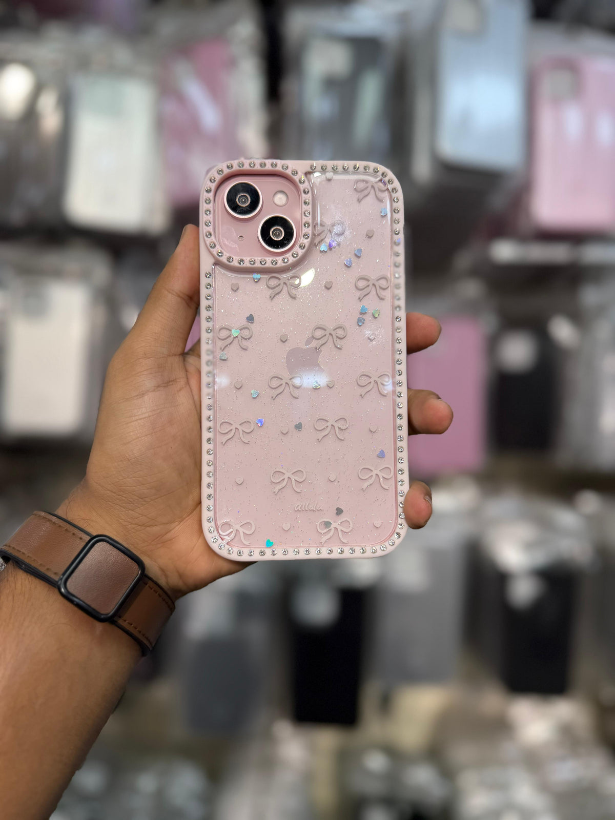Caseit Bow Crystal Luxe Case for iPhone with glitter hearts, bow pattern, rhinestone border, and shockproof protection